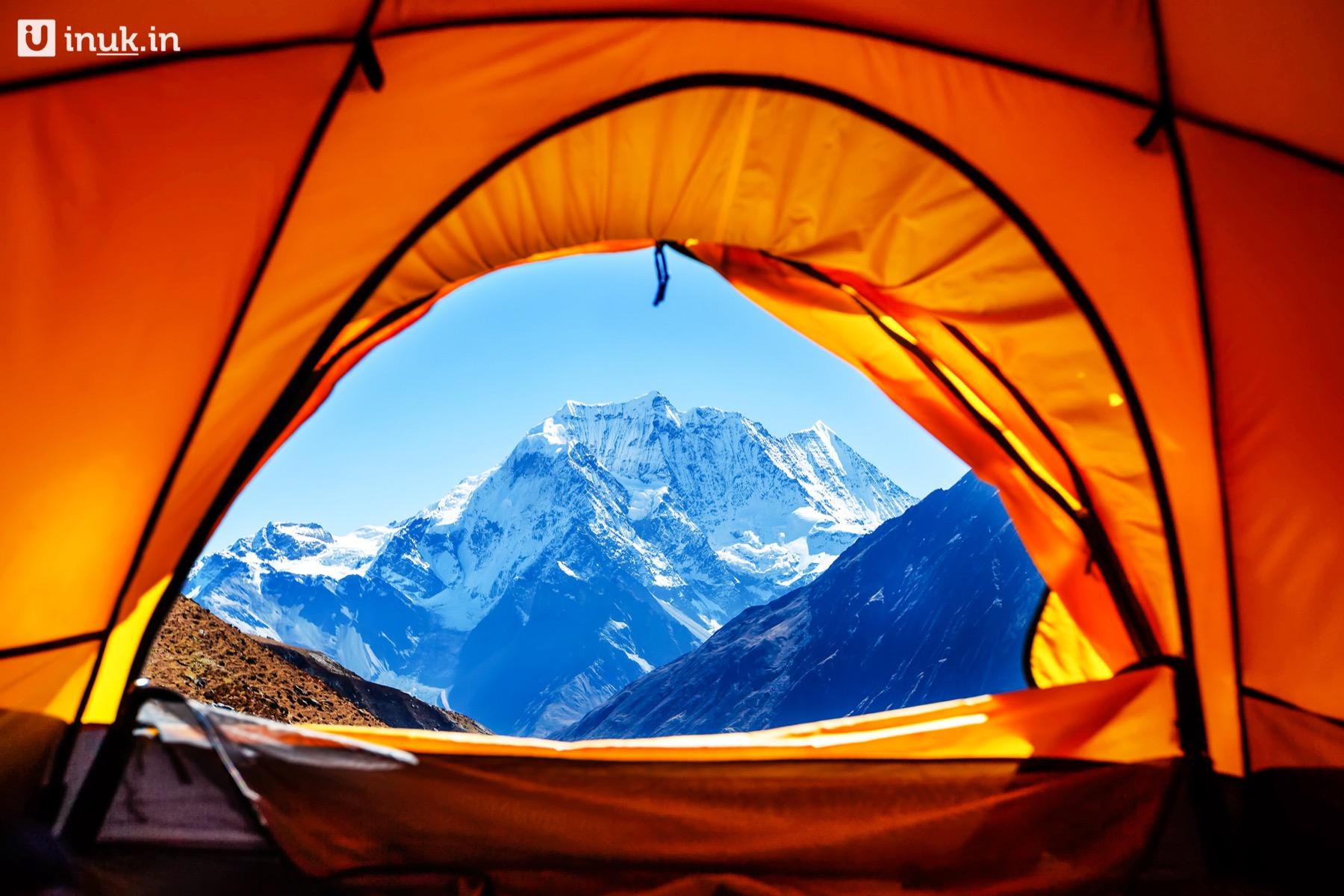 Tents pitched in the pines at a Simra Izar base camp